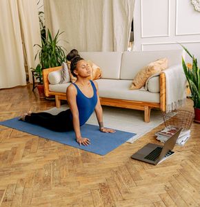 A calm practice space with a yoga mat and plants.